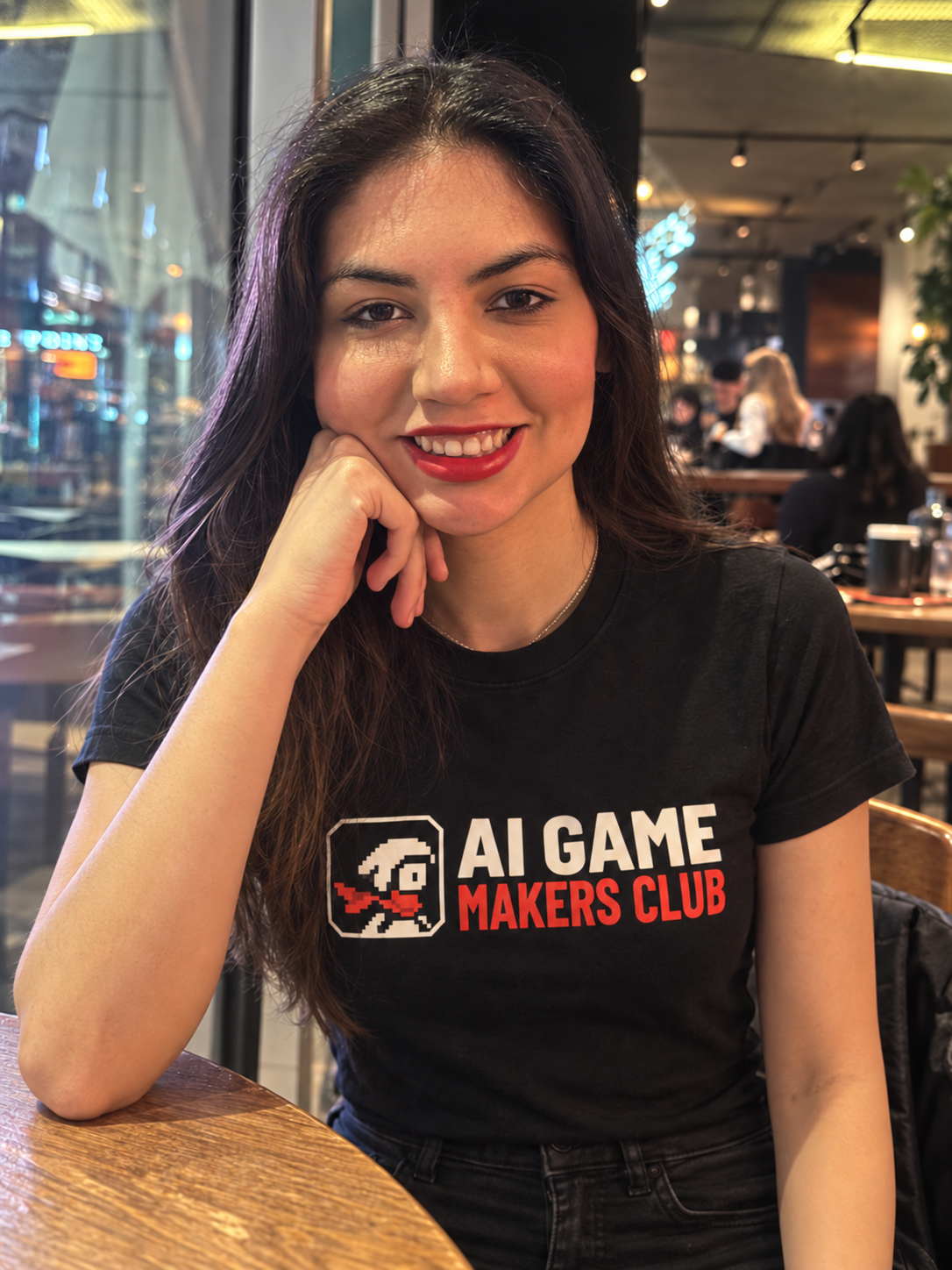 Isa, the creator of AI Game Makers Club, wearing the community T-shirt